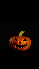 Happy Halloween, black background. Smiles orange pumpkin. Vertical banner, copy space