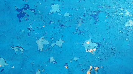Blue cracked paint, grunge abstract wall background.