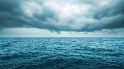 Obraz premium Calm ocean with overcast sky. Seascape photography with stormy weather. Ocean and sky interaction concept. Design for poster and wallpaper. Wide view with copy space 