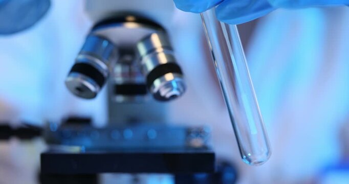 Test tube smear and microscope in laboratory conditions