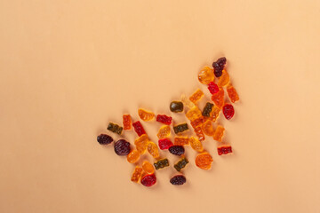 Fruit flavored worm shape, jelly candies. Isolated on cream background.