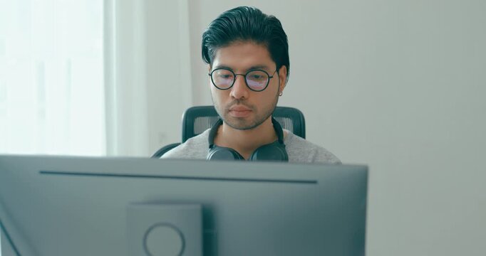 Young adult Asia male freelance eyeglasses typing write prompt AI bot IT app smart program nomad, video game, terminal with coding, user interface, designer, big data center on desktop computer.