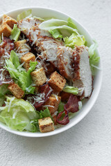 A bowl  of  Caesar salad
