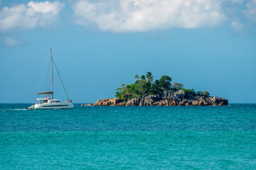 Tourists on sailing boat at St Pierre island, scenic rocky islet in Praslin island, Seychelles