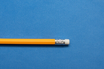 A pencil on blue background	
