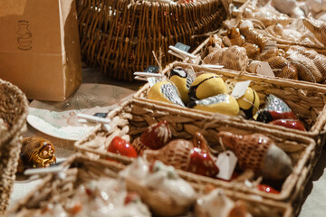 Sale of handmade ceramic Christmas tree toys at the Christmas Fair. Black Friday for the winter holidays.