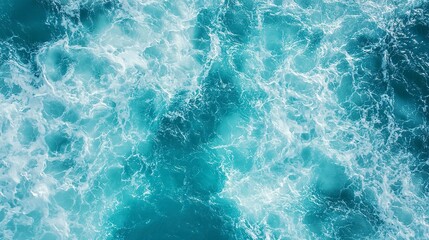 Fototapeta premium aerial view of turquoise ocean water with splashes and foam for abstract natural background and texture 