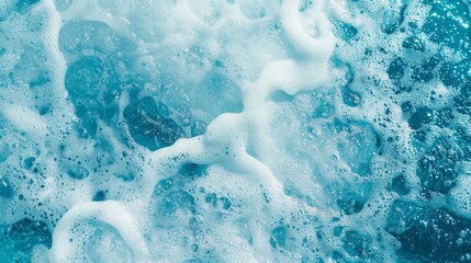 Close-up capture of frothy bubbles forming a delicate foamy texture on a blue surface of water.