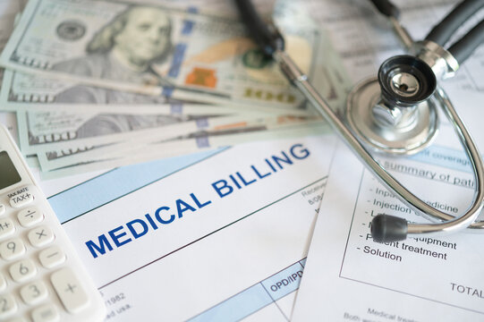 medical billing document and dollar banknote, calculator, stethoscope. medical treatment expense concept.