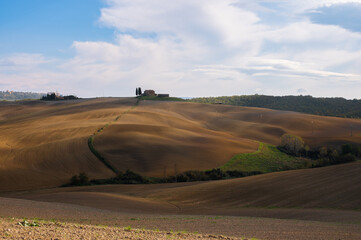 	
The picturesque authentic Italian scenery with plowed fields and blue sky in Tuscany, Italy. Pastoral landscape of Tuscany.
