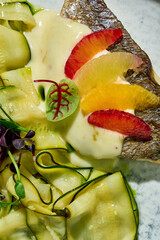 minimalist food photography composition featuring a seared sea bass fillet on bed of zucchini...