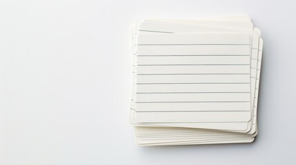 A scattered pile of white lined index cards, showcasing a more casual and dynamic arrangement, on a clean white surface.