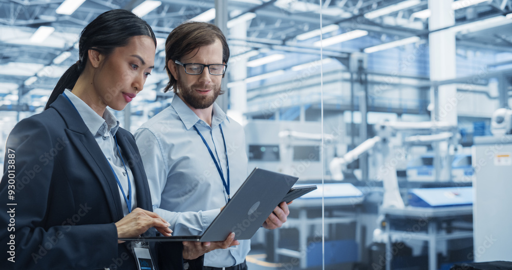 Leinwandbilder portrait of experienced male and female engineers standing in agency room, using computer devices an