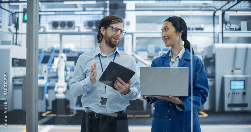 Aufkleber Caucasian Engineer and Asian Female Project Manager Standing in Office, Talking and Using Computers and Monitoring Production at a Modern Automated Electronics Manufacture with AI Robotic Arms