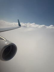 Fototapeta premium the engine of an aeroplane in flight above the clouds