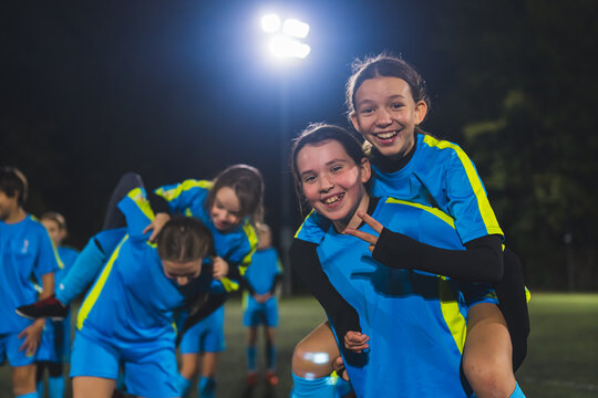 teammates hugging and celebrating victory. Two happy friends hugging on soccer field after sport match. High quality photo