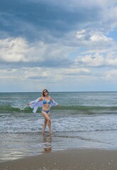 Fototapeta premium Vacation at sea, woman at Italy beach. Lady in bright swimwear