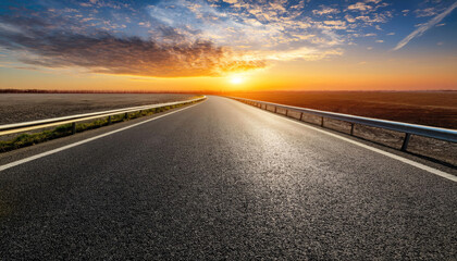 Fototapeta premium empty asphalt highway and nature landscape at sunset