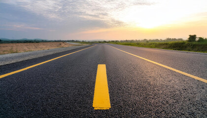 Obraz premium empty asphalt highway and nature landscape at sunset