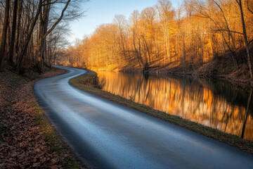 Fototapeta premium Twisting Road Along a Riverbank with Reflections