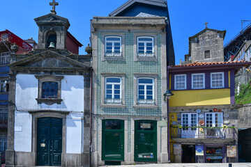 Facade of colorful buildings among the streets of the old city in Porto, Portugal.