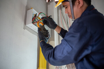 Fototapeta premium An electrician is wiring the house Electrician Working on Electrical Wiring in a New Construction