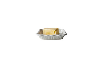 A block of butter sits in a white ceramic dish_Transparent background PNG