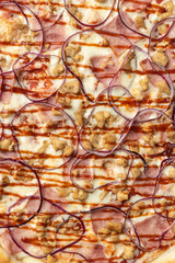 the macro composition of pizza for the menu. fresh ingredients are cheese, ham and tomatoes.