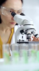 Woman scientist using microscope in laboratory. Microbiology science concept