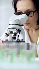 Woman scientist using microscope in laboratory. Microbiology science concept