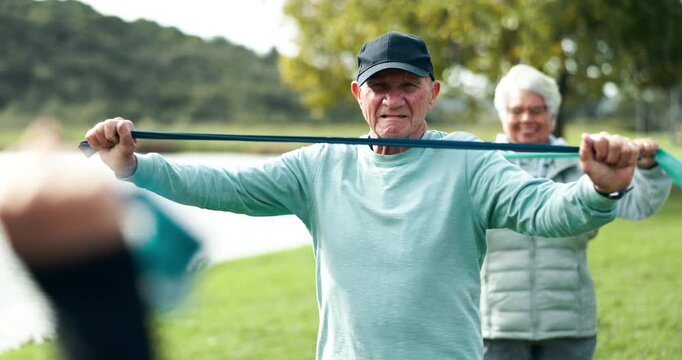 Fitness, band and elderly people in park with personal trainer for health, wellness or resistance training. Physio, muscle and group of senior friends on grass for workout, stretching and mobility