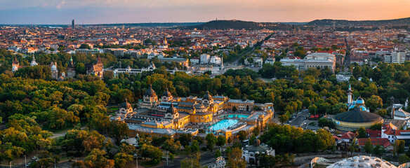 Budapest, Hungary - Aerial panoramic view of City Park (Varosliget) at sunset time. In this view includes Szechenyi Bath, Heroes' Square, Vajdahunyad Castle, Andrassy Street, and St.Stephens Basilica