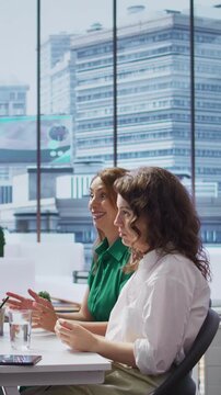 Vertical Video HR expert interviewing two job applicant to fill a vacancy within the organization, talent acquisition. Male recruiter discussing with talented businesswomen with impressive CVs. Camera