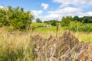 Obraz premium Summer afternoon in the Cotswold village of Middle Duntisbourne, Gloucestershire, England UK