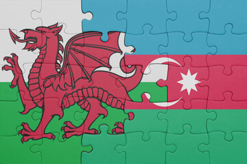 puzzle with the colourful national flag of azerbaijan and flag of wales .