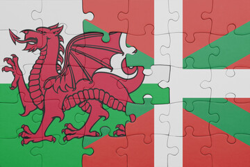 puzzle with the colourful national flag of basque country and flag of wales .