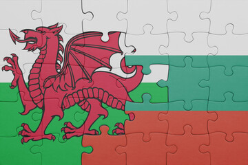 puzzle with the colourful national flag of bulgaria and flag of wales .