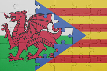 puzzle with the colourful national flag of catalonia and flag of wales .