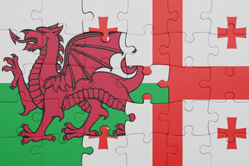 puzzle with the colourful national flag of georgia and flag of wales .