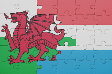 puzzle with the colourful national flag of luxembourg and flag of wales .