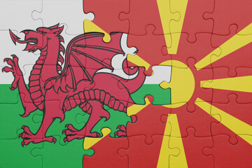 puzzle with the colourful national flag of macedonia and flag of wales .
