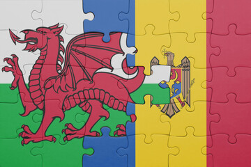 puzzle with the colourful national flag of moldova and flag of wales .