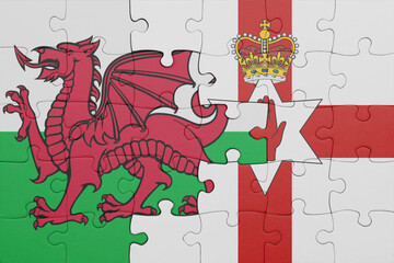 puzzle with the colourful national flag of northern ireland and flag of wales .