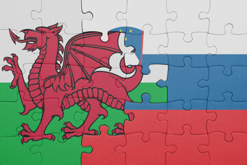 puzzle with the colourful national flag of slovenia and flag of wales .