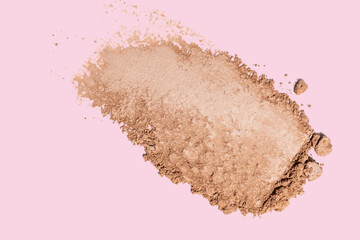 Eye shadow texture swipe isolated on pink background. Cosmetic product swatch. Make up mate nude...