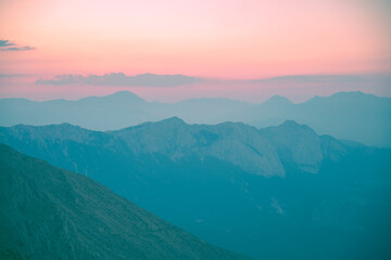Obraz premium Silhouettes of mountains in a beautiful gentle haze, mountains at sunset or sunrise, natural background