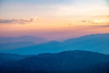 Obraz premium Silhouettes of mountains in a beautiful gentle haze, mountains at sunset or sunrise, natural background