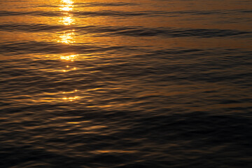 sea background, sunset or sunrise on the sea, a path of light on the water on dark sea background,...