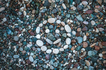 Smiling smiley face lined with white stones on the beach, the concept of relaxation, vacation at the seaside, joy and pleasure