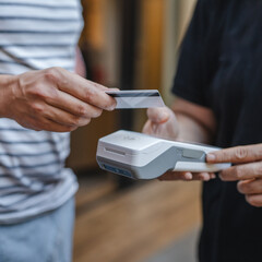 Unknown adult man have contactless payment with credit card